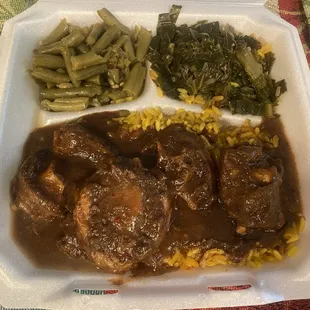 Oxtails, green beans, yellow rice and collard greens