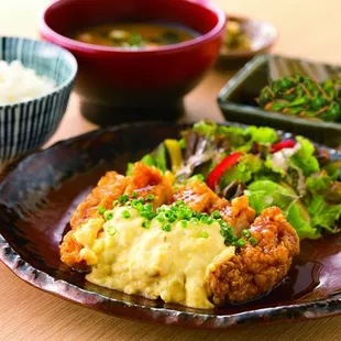 a plate of food with rice and vegetables