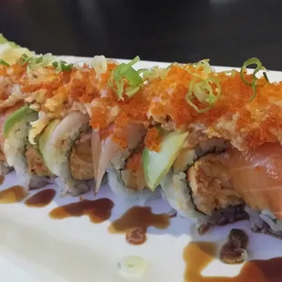 Titanic Roll (Shrimp Tempura, Spicy Crab Meat, topped w/ Hamachi, Salmon, Avocado, Lobster Salad, Scallion, Tobiko &amp; Unagi Sauce) @ $10.95..