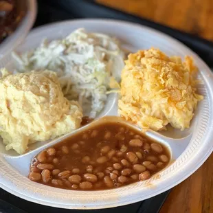 a plate of beans, mashed potatoes, and baked beans