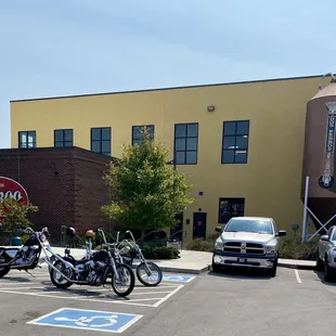 a row of motorcycles parked in a parking lot