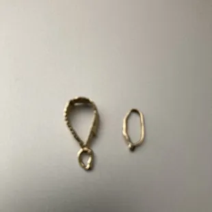 Gold cross and gold pendant broke from cheap repair.