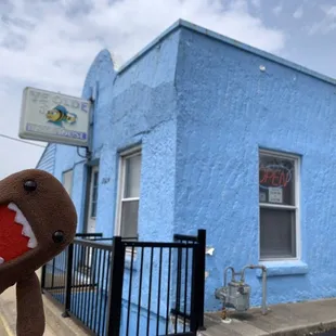 When you see the blue building, you're here!