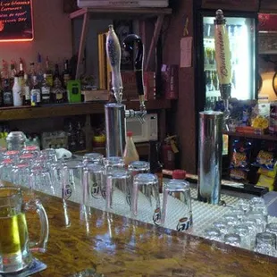 a bar with a lot of glasses on the bar