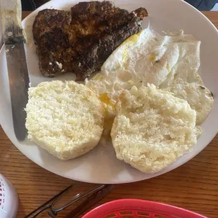 Pork steak breakfast. Biscuits are light and fluffy. Delicious