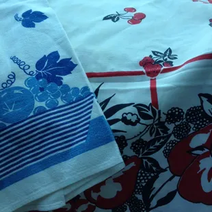 Vintage towel on the left and vintage tablecloth with fruit on the right