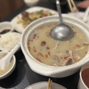 a bowl of soup with chopsticks