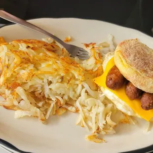 a breakfast sandwich and hash browns
