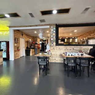 a dining area with tables and chairs