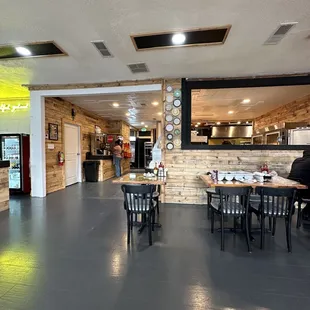 a dining area with tables and chairs