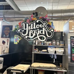 a sign for yellow brick pizza