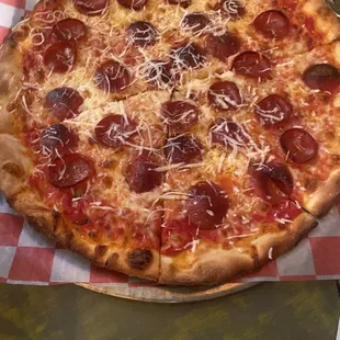 a pepperoni pizza on a table