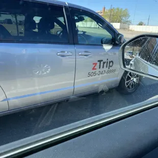 Road raging minivan driver with the company name on the vehicle.