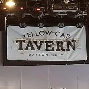 a stage with a yellow cab tavern sign
