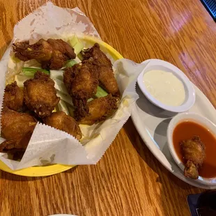 Wings come dry with a giant side of hot sauce and blue cheese