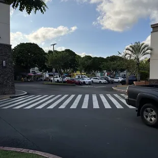 a parking lot with cars parked on the side of the road