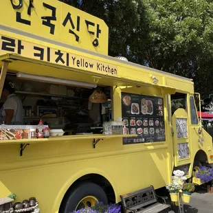 a yellow food truck parked in a parking lot