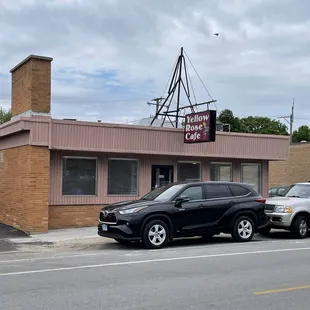 two cars parked in front of the building