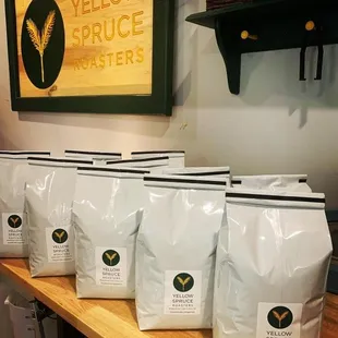 a row of bags of yellow spruce roasters