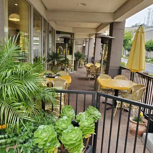 a patio with tables and chairs