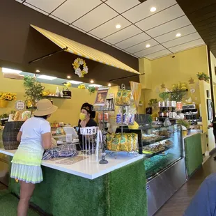 a woman standing at a counter in a store