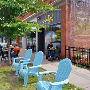 blue chairs in front of a brick building