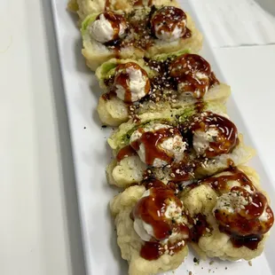 a long rectangular platter of sushi