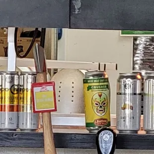 a counter with beer cans and a clock