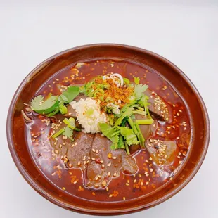  of a bowl of soup with meat and vegetables