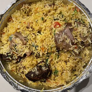 a bowl of rice with meat and vegetables