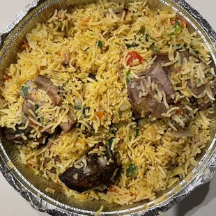 a bowl of rice with meat and vegetables
