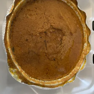 a pumpkin pie in a foil pan