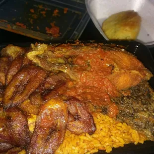 Fish with jollof rice and plaintain.  Meatpie in the back.