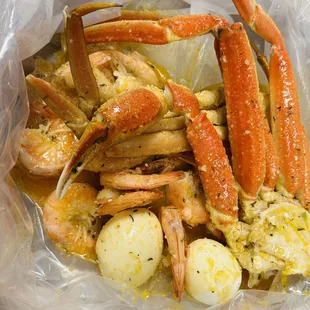 crab legs and potatoes in a plastic bag