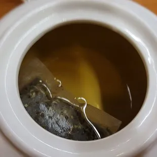 The Itty bitty tea bag in warm water. Don&apos;t be fooled by this picture! The shadows makes it look like I actually got tea!