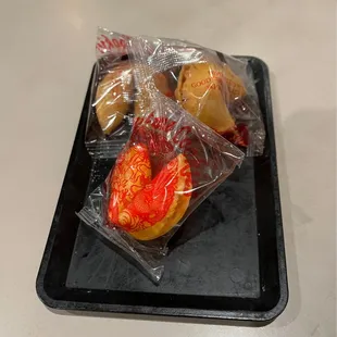 a tray of pastries wrapped in plastic