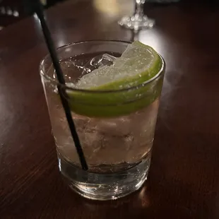 a glass of water and a lime slice