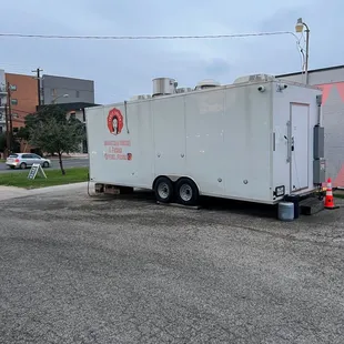 The back of the food truck and the parking lot area