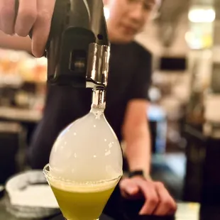 a person pouring a drink