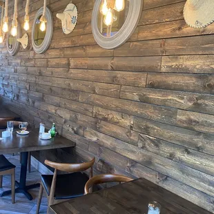 a restaurant with wooden tables and chairs