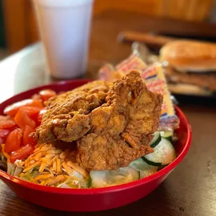 a bowl of fried chicken and salad