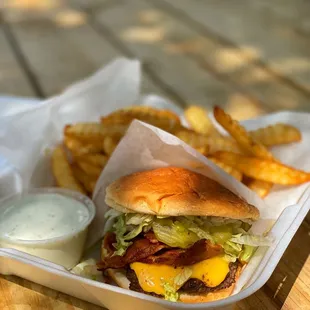 a burger and fries on a picnic table