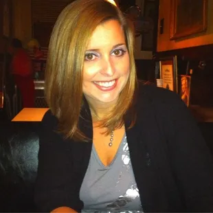 a woman sitting at a table with a plate of food