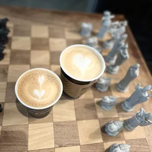 Cappuccino and Honey Lavender Latte on the Harry Potter themed chess board with a few missing pieces.