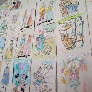 The coloring book pages on the wall are pretty cute.