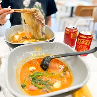  woman eating noodles with chopsticks