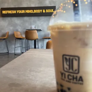 Inside with iced latte with vanilla and boba. Beware of price!