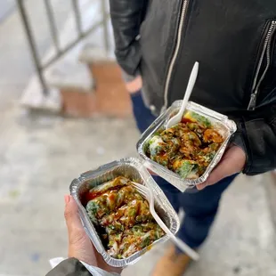 two takeout containers of food