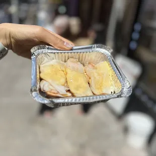 a person holding a tray of food