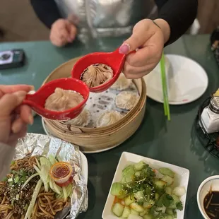 a woman holding a red spoon